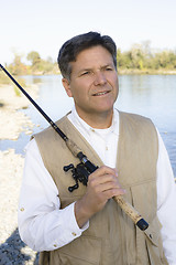 Image showing Man Standing With Fishing Pole