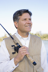 Image showing Man Standing With Fishing Pole