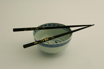 Image showing Black chopsticks with chinese bowl