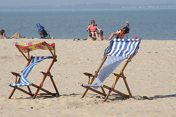 Image showing colorful deckchairs on beach