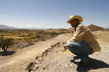 Image showing Handsome man with a hat, watching over the land