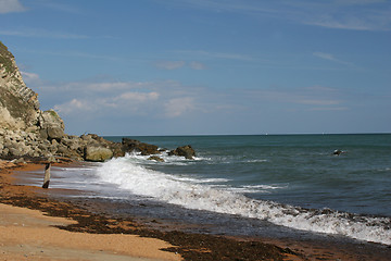 Image showing Surf crashing on rocky beach