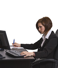 Image showing Businesswoman taking notes at her desk.