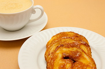 Image showing Closeup of coffee with milk in white cup and a palmier pastry