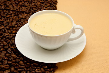 Image showing White cup of coffee and coffee beans