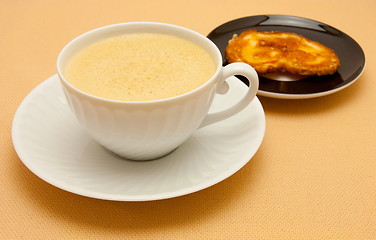 Image showing Closeup of coffee with milk in white cup and a palmier pastry