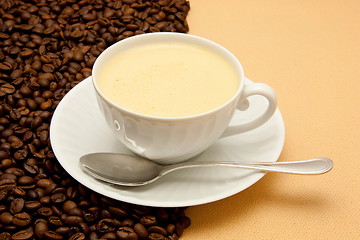 Image showing White cup of coffee and coffee beans