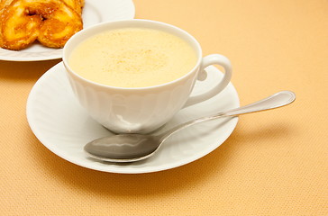 Image showing Closeup of coffee with milk in white cup and a palmier pastry