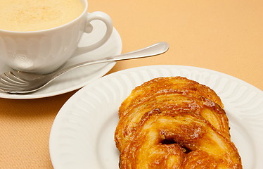 Image showing Closeup of coffee with milk in white cup and a palmier pastry