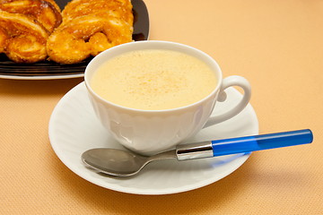 Image showing Closeup of coffee with milk in white cup and a palmier pastry