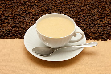 Image showing White cup of coffee and coffee beans