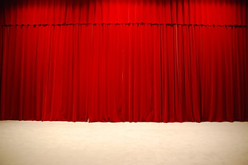 Image showing Red draped theater stage curtains