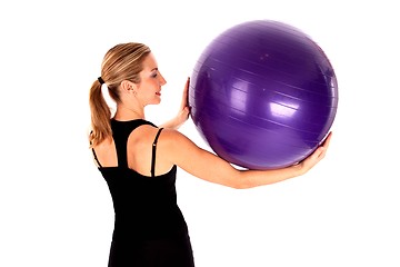 Image showing Young woman doing yoga ball exercises isoalted