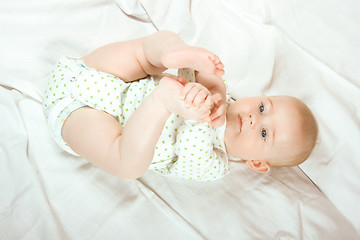 Image showing Baby plays with her legs