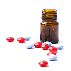 Image showing glass bottle with red and blue pills