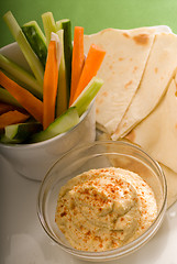 Image showing hummus dip with pita bread and vegetable