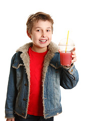 Image showing Happy healthy boy holding fresh fruit juice in clear cup