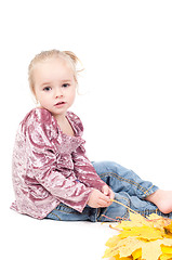 Image showing Toddler with maple leaves