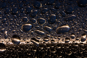 Image showing raindrops on the chrome handrail