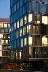 Image showing office building from glass in the evening with the windows