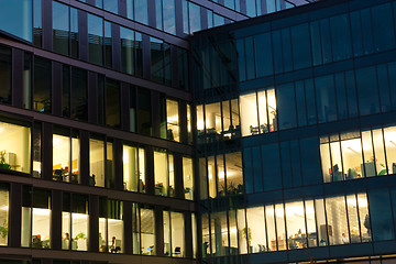 Image showing office building from glass in the night with the windows