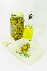 Image showing Stuffed pickled Olives in dish with olive oil. 