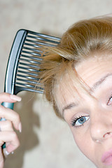 Image showing pretty woman to comb hairs