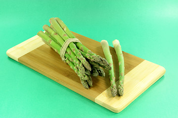 Image showing Pile of asparagus over green background. 