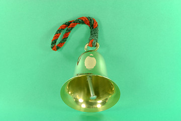 Image showing Hand bell over green background. 