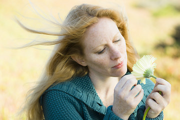 Image showing Woman Looking at Flower