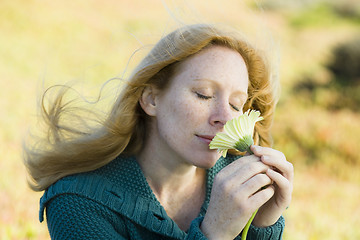 Image showing Woman Smelling Flower