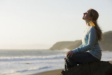 Image showing Woman Sitting on Rock