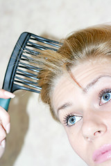 Image showing pretty woman to comb hairs 