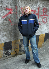 Image showing Man by a wall