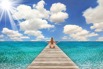 Image showing Beach Scene on a Bright Day With Woman Meditating