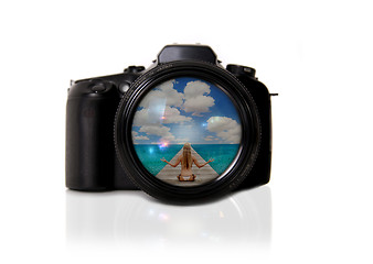 Image showing Digital SLR Isolated With Reflected Image of the Beach in the Le