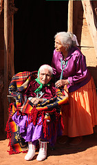 Image showing Women in Front of Their Family Traditional Hogan Hut