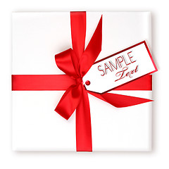 Image showing Pretty Wrapped Holiday Gift With Red Ribbon and Gift Tag