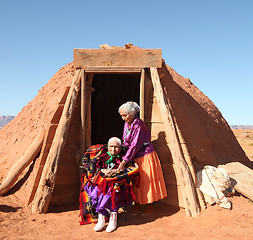 Image showing 2 Navajo Women Outside Their Traditional Hogan Hut