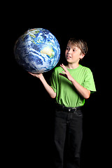 Image showing Boy holding Earth in his hand and looking with wonder fascinatio