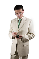 Image showing Businessman with PDA looking over his glasses