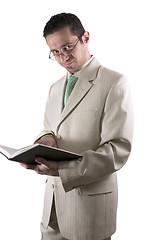 Image showing Businessman with a pair of glassed reading a book