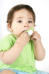 Image showing Baby putting a dummy into mouth