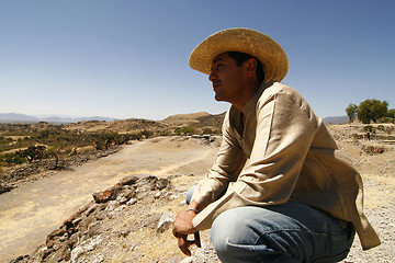 Image showing Handsome man with a hat, watching over the land