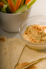 Image showing hummus dip with pita bread and vegetable