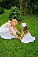 Image showing Young mother and daughter playing in meadow