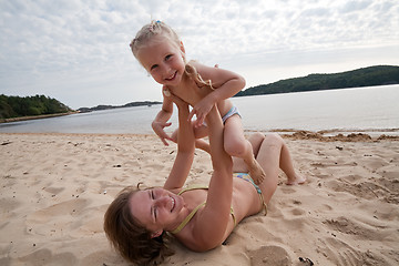 Image showing Mum with daughter play on beach