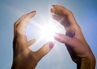 Image showing hands and sun