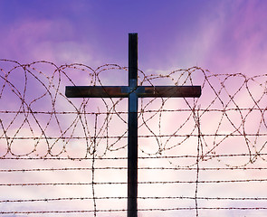 Image showing cross of christ behind barbed wire