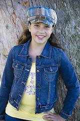 Image showing Tween Girl Leaning Against Tree In Park